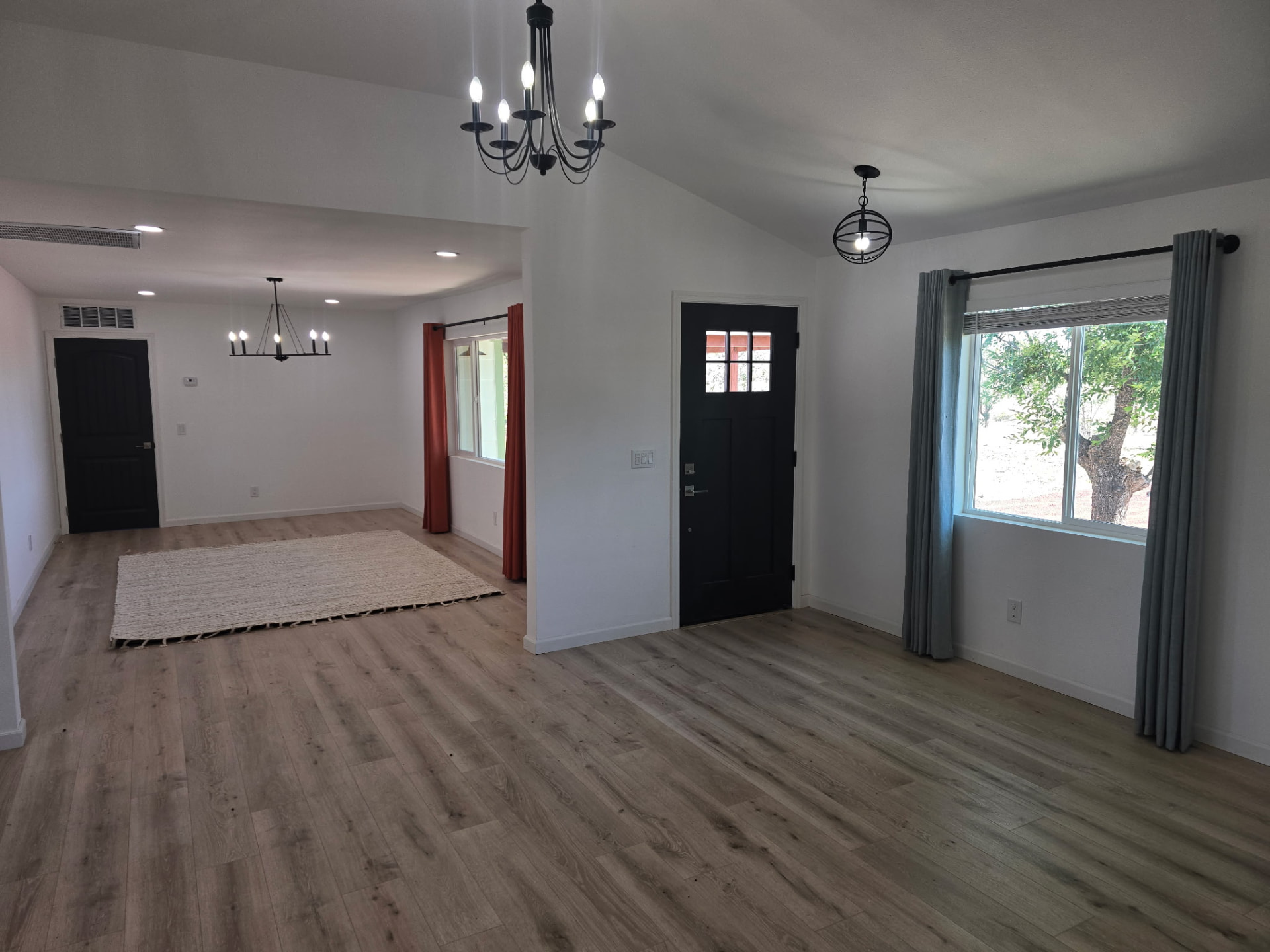 Empty entryway and dining room photographed with a phone