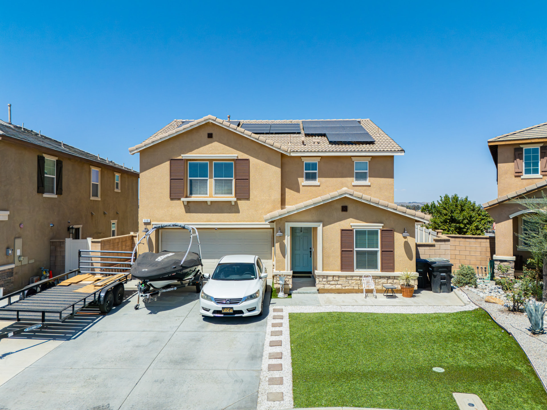 Aerial drone photo of a two-story home's front elevation and driveway